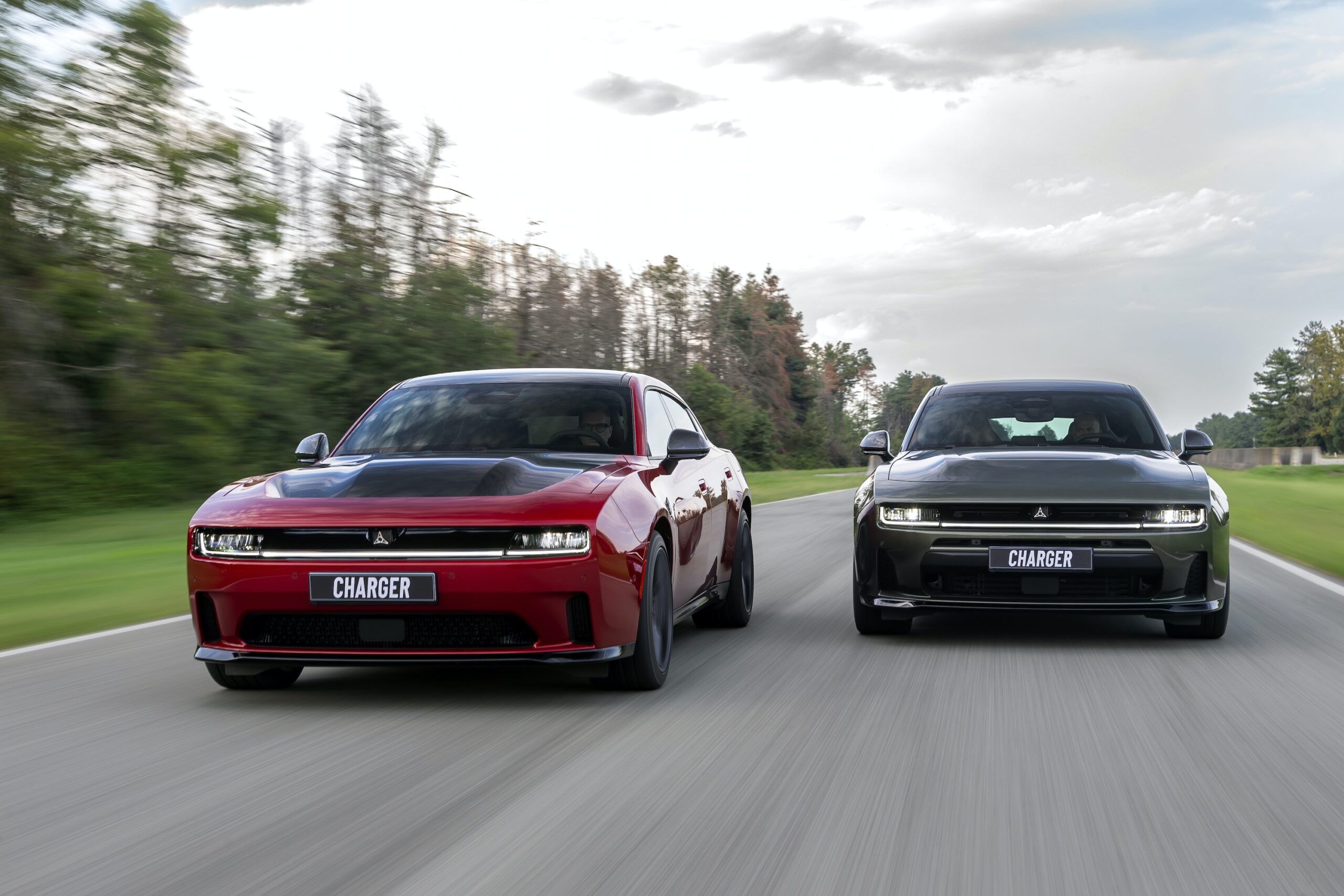 Red and black Dodge Charger models driving side by side on a road