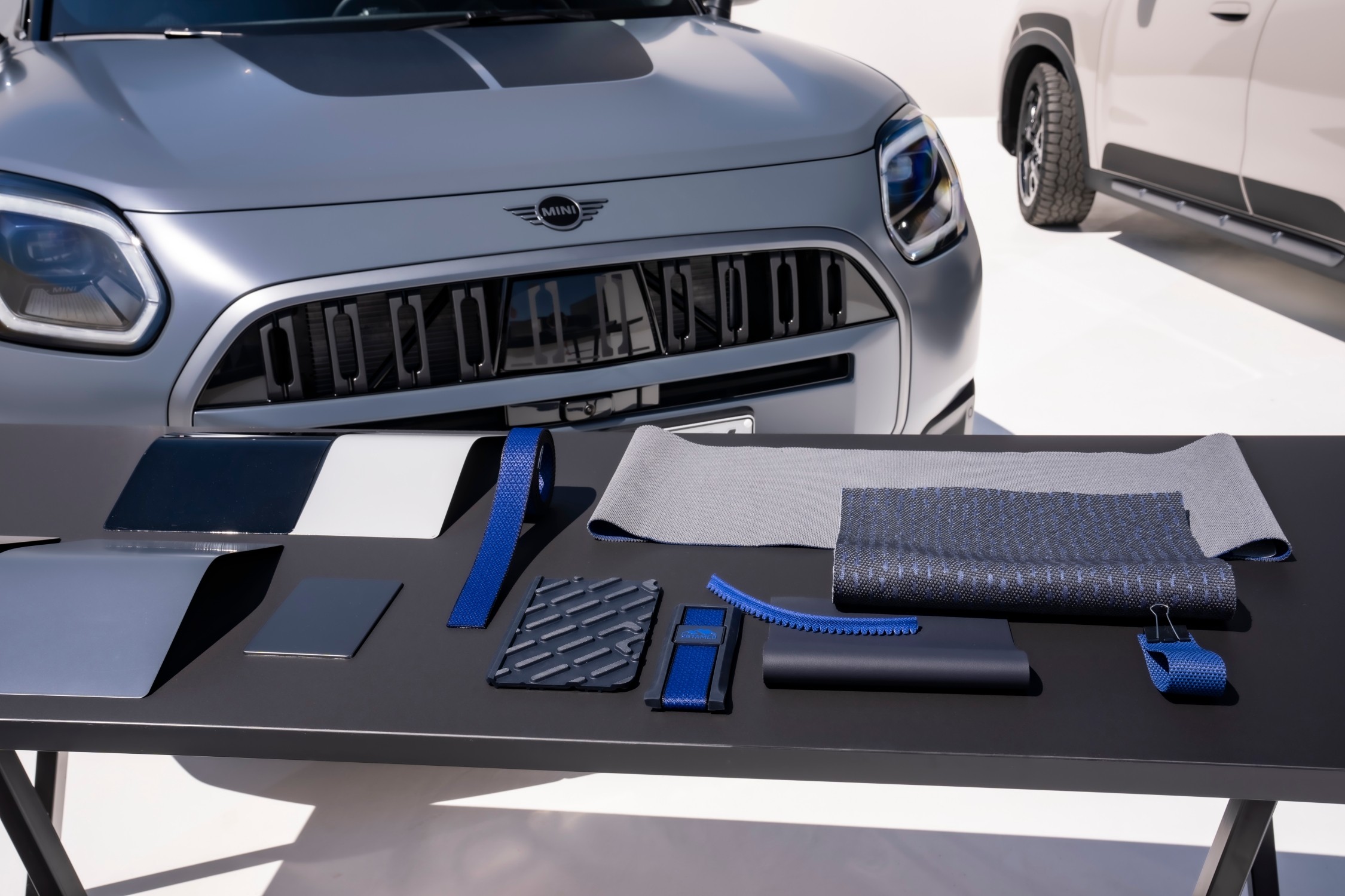 Grey MINI Countryman Untamed Edition displayed in a studio with its outdoor-inspired trim materials
